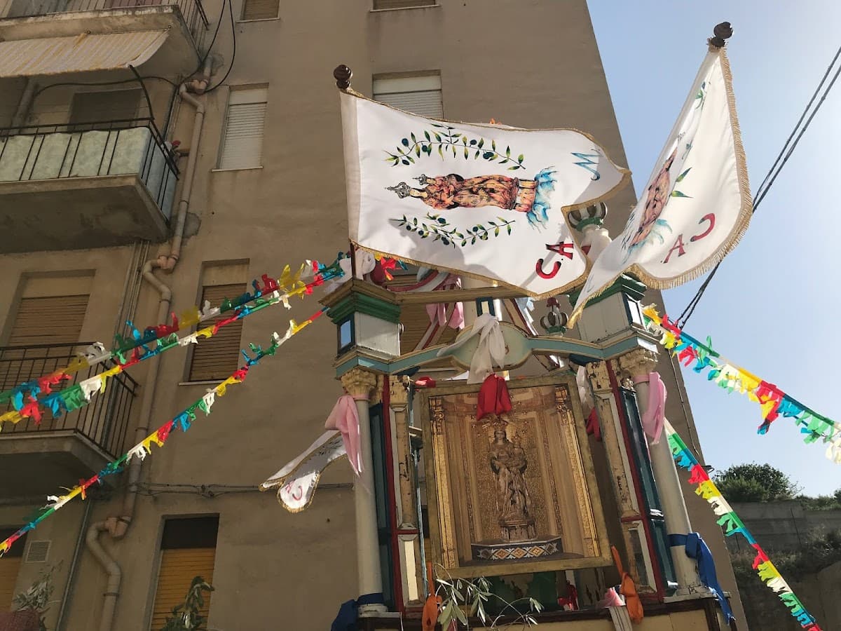 A historic cilio decorated with painted flags and ribbons during Festa del Monte